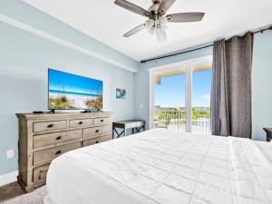 a bedroom with a bed and a tv and a window at Laketown Wharf 331 in Panama City Beach