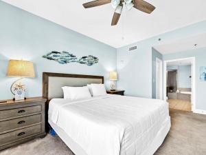 a bedroom with a white bed and a ceiling fan at Laketown Wharf 331 in Panama City Beach +53 photos