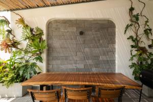 a table and chairs in front of a brick wall at Venice Home Serenity in Phan Thiet