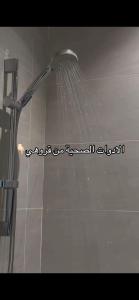a shower with a shower head in a bathroom at Khobar Apartments in Al Khobar