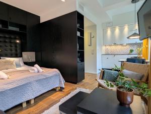 a bedroom with a large bed and a living room at Forenom Hotel Apartments Geijersgatan - City Center in Gothenburg