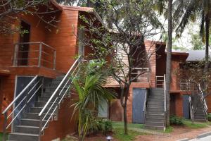 a house with a staircase on the side of it at Royal Orchid Resort & Convention Centre, Yelahanka Bangalore in Bengaluru