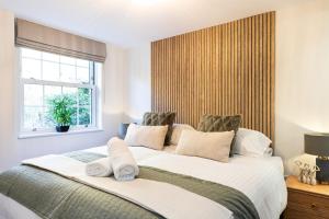 a bedroom with a large white bed with a window at Rock Mill 1 Bed Apartment 15 in Stoney Middleton