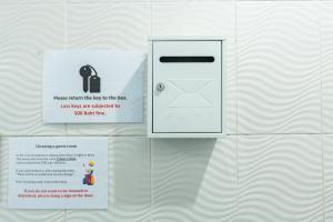 a white door with a sign on a wall at X The Hidden Giant Swing เดอะ ฮิดเด้น เสาชิงช้า in Bangkok +27 photos