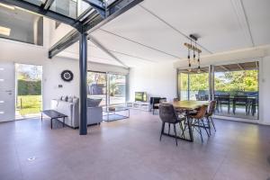 un soggiorno con tavolo e sedie di Villa spacieuse avec piscine privée à Toulouse a Tolosa