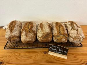 a group of freshly baked loaves of bread on a rack at Tatis Bake-Away in Roundstone
