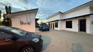 a car parked in a parking lot next to a building at DVilla in Tangkak