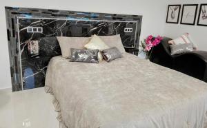 a bedroom with a large bed with pillows at Casa Babu in Solares