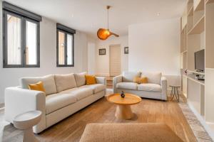 a living room with a couch and a table at La Dommarienne - Collection Idylliq in Dommiers