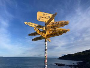 a street sign with many signs on a pole at Oceans Edge Three-bed rooms spacious house in Bluff in Bluff