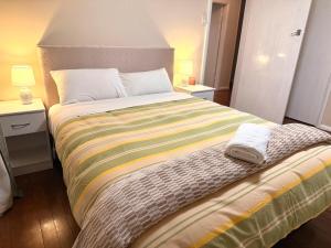 a bedroom with a large bed with two night stands at Oceans Edge Three-bed rooms spacious house in Bluff in Bluff