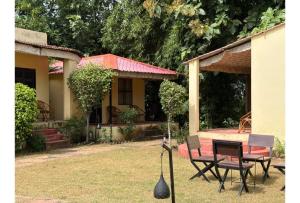 a house with a table and chairs in the yard at Shikaar Valley in Khilchipur