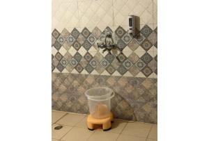 a trash can with a plastic bucket in a bathroom at Shikaar Valley in Khilchipur