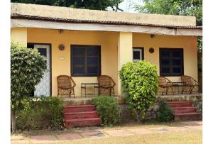 a house with chairs and a table on the porch at Shikaar Valley in Khilchipur
