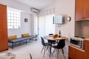 a kitchen and living room with a table and chairs at Venetian Studio in the Centre 1 in Heraklio