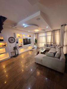 a large living room with a couch and a table at IBIZA LAGoS in Lagos