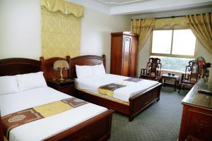 a hotel room with two beds and a window at Retro Homestay Hạ Long in Ha Long +80 photos
