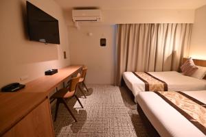 Ένα ή περισσότερα κρεβάτια σε δωμάτιο στο Henn na Hotel Express Osaka Namba Nipponbashi