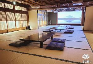 a large room with tables and a large screen at 鈴籠城 籠の間 in Nagahama