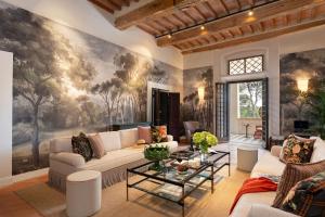 a living room with a large painting on the wall at Fattoria di Vegi in Castellina in Chianti