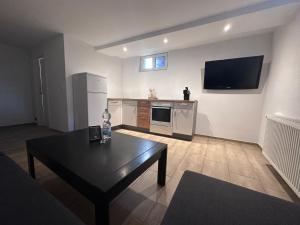 a living room with a table and a tv on the wall at Montage- Pendlerwohnung in Kandern