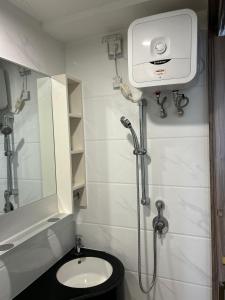 a bathroom with a shower and a toilet and a mirror at Sky House Studio Apartment in CBD BSD near AEON and ICE in Cilenggang