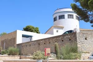 a building with a lighthouse on top of a wall at La Torre Blai in Jijona