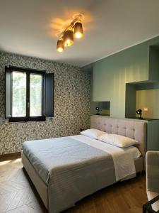 a bedroom with a large bed and a window at Casale Corneli in Silvi Paese