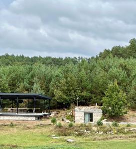 a pavilion in a field with trees in the background at Family comfort 