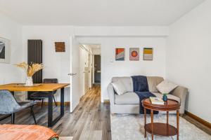 a living room with a couch and a table at Deluxe Studio Flat - King's Cross - by KeyHol Holiday Let in London