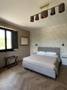 a bedroom with a large bed and a wall at Casale Corneli in Silvi Paese