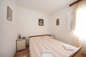 Ένα ή περισσότερα κρεβάτια σε δωμάτιο στο Apartments Mira