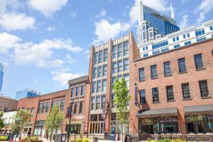 a large brick building on a city street at The Saddlery - Sound Check - 1 Block to Broadway in Nashville