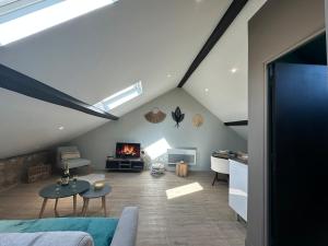 a attic living room with a couch and a fireplace at C Copenhague - charmant studio proche centre-ville in Charleville-Mézières