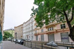 a building on a street with cars parked in front at Room & Parking Assistance in Prague