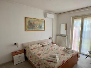 a bedroom with a bed with towels on it at Morbegno House in Morbegno