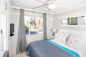 a white bedroom with a bed and a window at Mount Currie Inn in Kokstad +37 photos