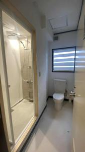 a bathroom with a shower and a toilet at Nona Madarao in Madarao Kogen