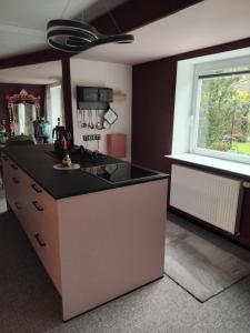 a kitchen with a black counter top and a window at Art Place Home in Rückersdorf
