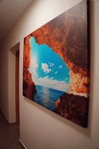 a painting of the ocean on a wall at GP Hostel in Šiauliai