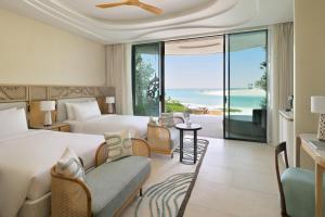 a hotel room with a bed and a view of the ocean at InterContinental The Red Sea Resort by IHG in Ḩanak