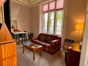 a living room with a couch and a table at Court Residence Aparthotel in Linlithgow