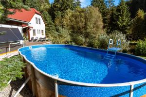 a large blue pool with a fence around it at Penzion U rybníka in Šumperk