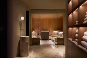 a bathroom with a walk in shower and a glass door at The Newman in London