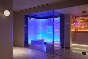 a room with a glass door with a table in it at The Newman in London