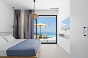 a bedroom with a bed and a view of the ocean at Villa Lulu Lefkada in Kalamitsi +38 photos