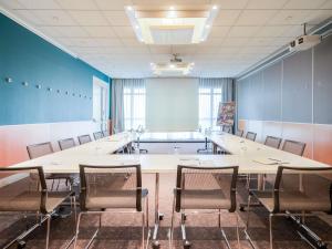 a conference room with a large table and chairs at Novotel Metz Amnéville in Maizières-lès-Metz