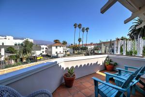 two chairs on a balcony with a view of a city at Casa Azzurra in Santa Barbara