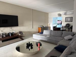 a living room with a couch and a table at Casa Confort Belém in Belém