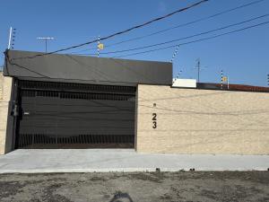 a large building with a large black garage at Casa Confort Belém in Belém